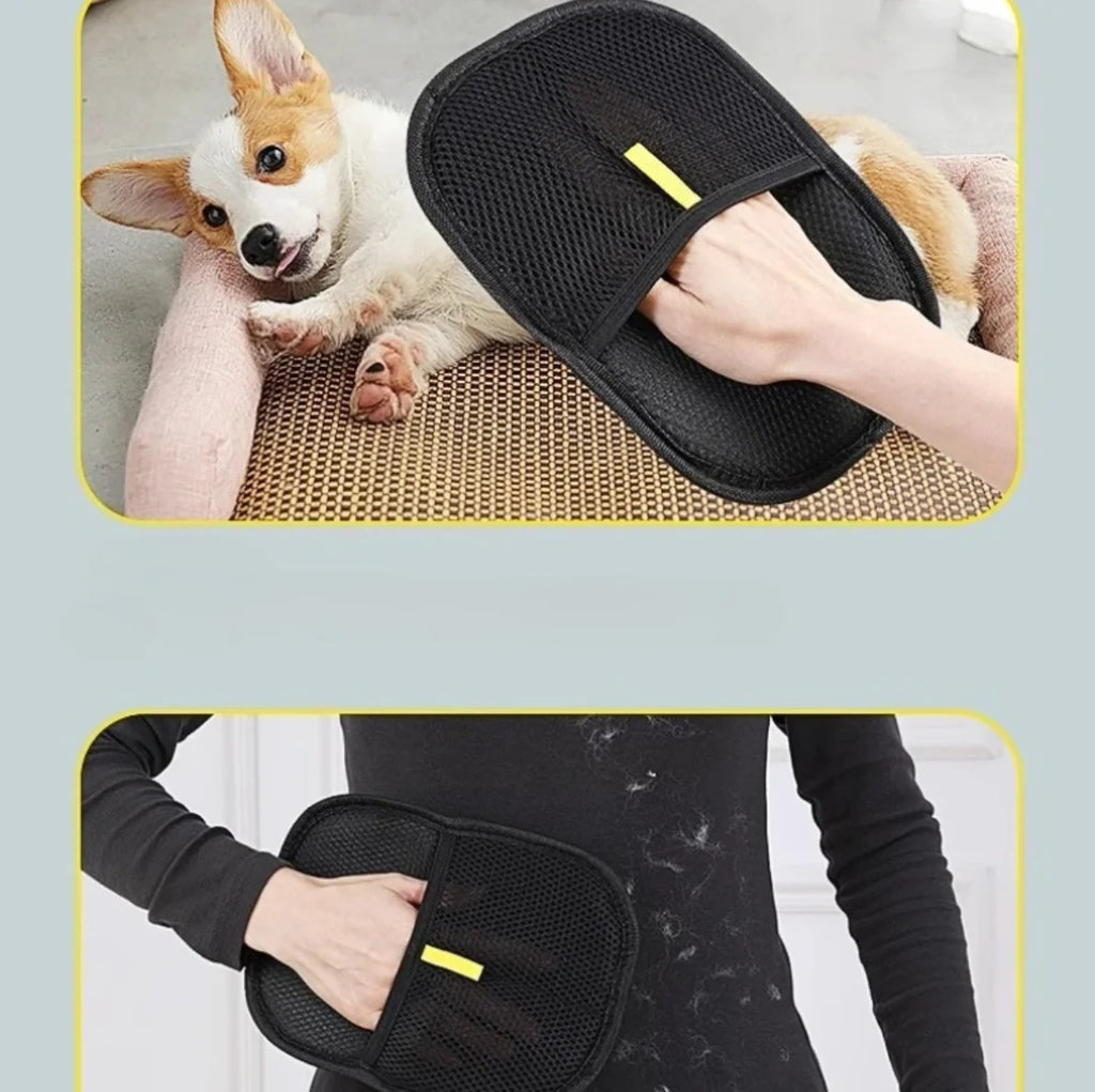 Black pet grooming brush held by a person with a dog lying on a mat in the background.